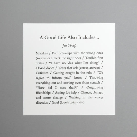 Front view of “A Good Life Also Includes…” 5×5 black letterpress print by Jen Shoop on white paper.