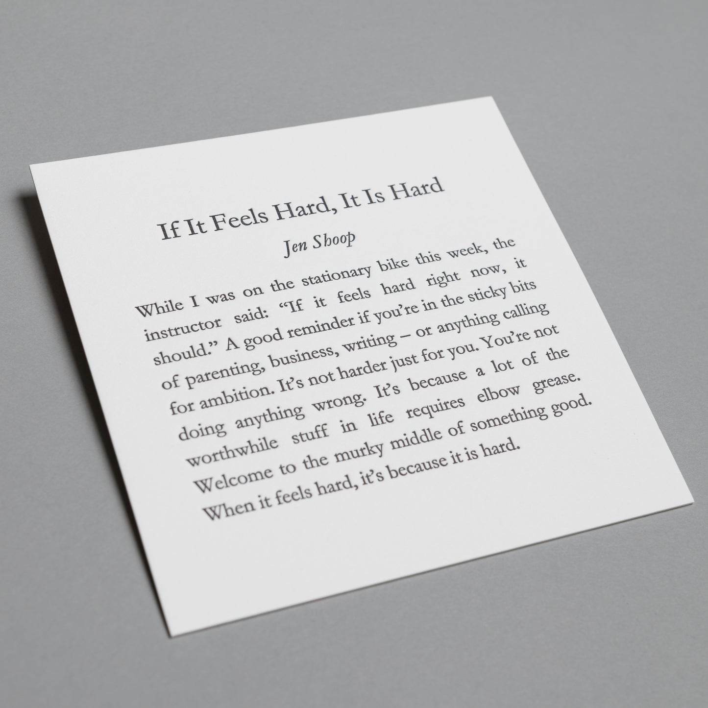 Angled view of “If It Feels Hard, It Is Hard” 5×5 letterpress print with impressed black type.