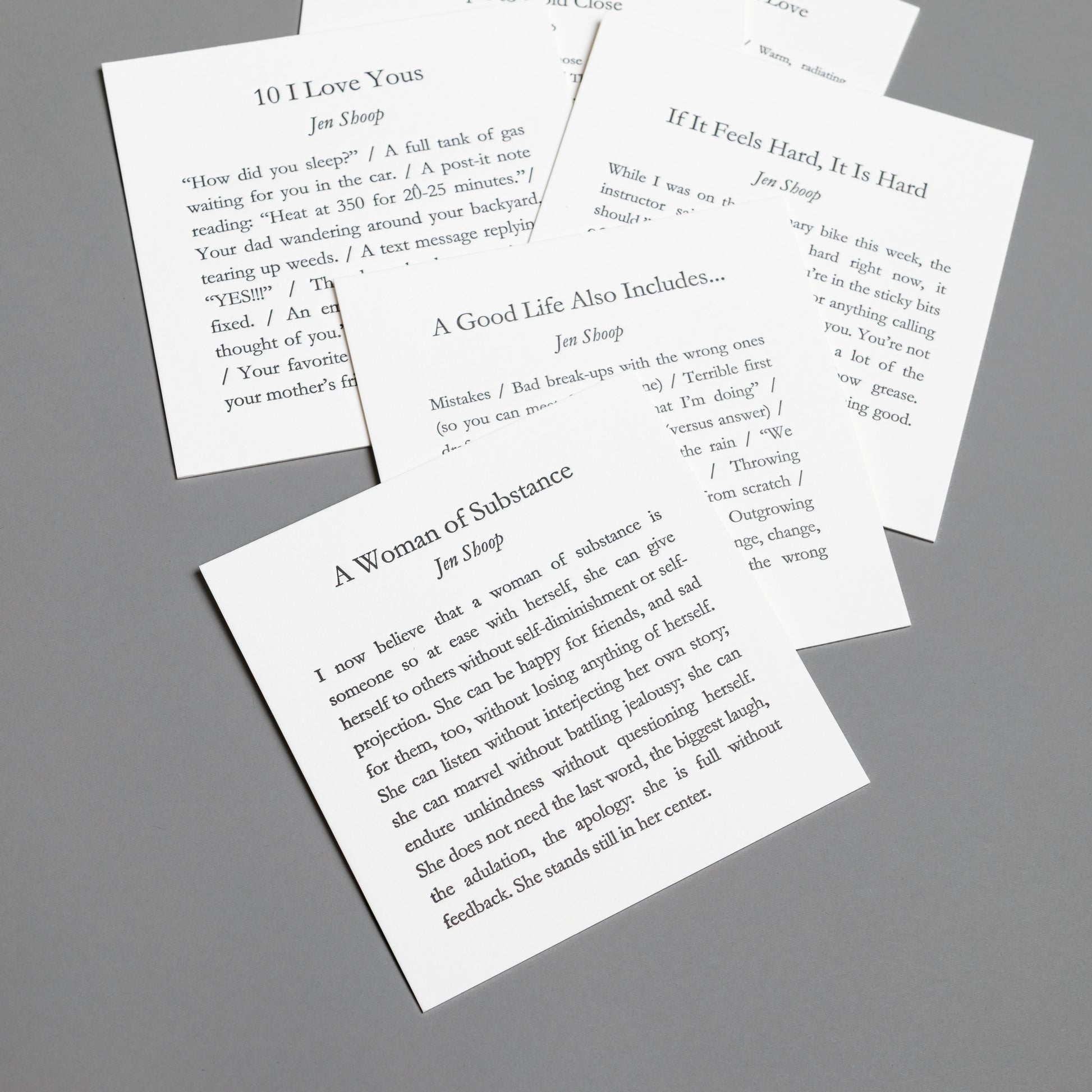 Alternate collection view of Jen Shoop’s six 5×5 letterpress prints with black type on white paper.